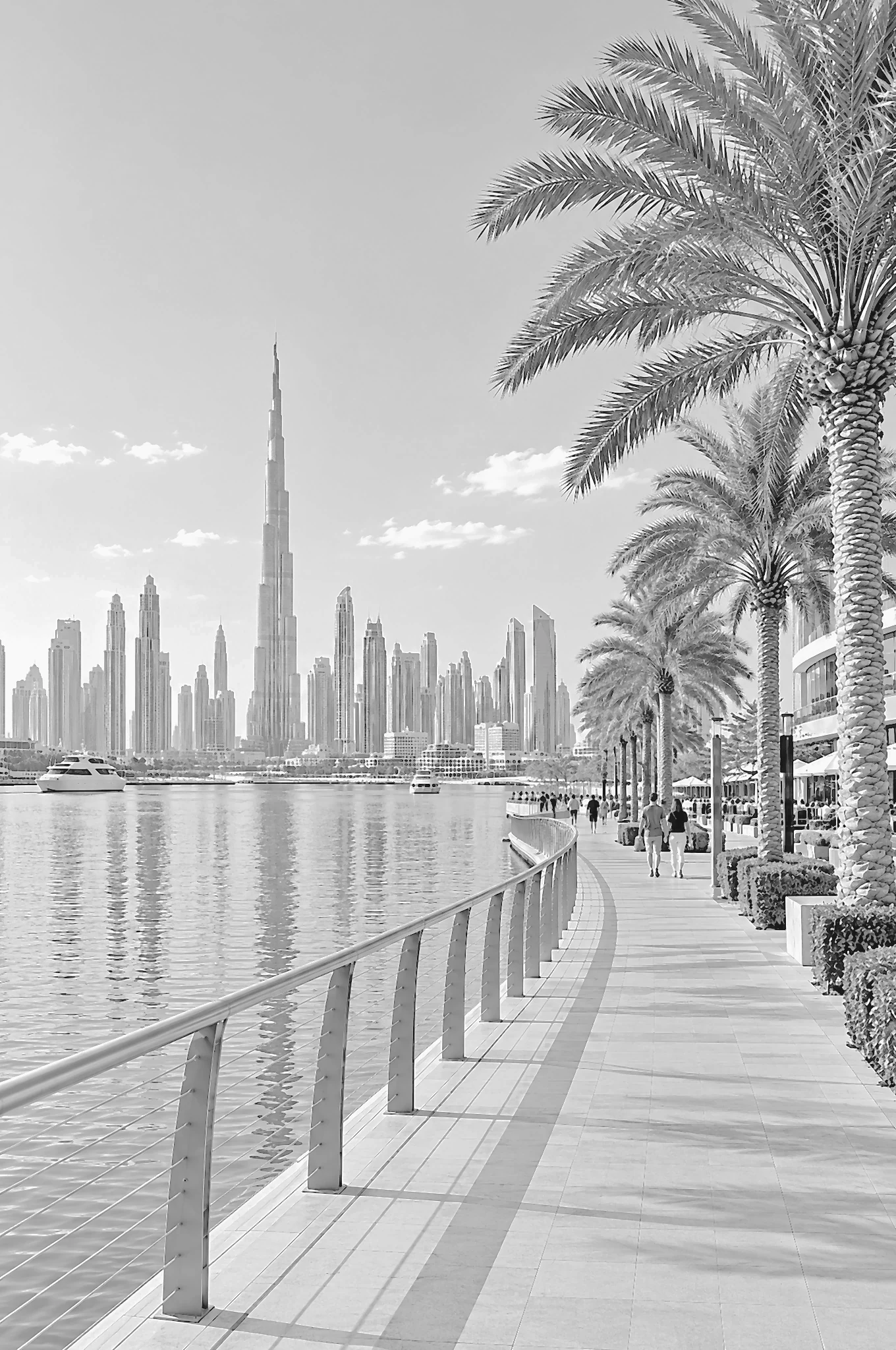 Palm-lined Dubai waterfront promenade at late afternoon
